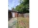 A fully fenced backyard offers privacy, shade trees, and room to entertain at 4712 Rockstile Way, Stone Mountain, GA 30083