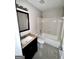 This bathroom offers a shower-tub combo, vanity with storage, and neutral finishes at 4712 Rockstile Way, Stone Mountain, GA 30083