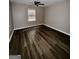 Inviting bedroom with dark wood-look floors, neutral paint, and natural light at 4712 Rockstile Way, Stone Mountain, GA 30083