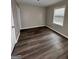 This bedroom features fresh paint, modern flooring, and a bright window at 4712 Rockstile Way, Stone Mountain, GA 30083