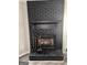 Close-up of a stylish black brick fireplace with mantle and hearth at 4712 Rockstile Way, Stone Mountain, GA 30083