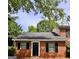 Charming brick home featuring classic black shutters and a well-manicured lawn at 4712 Rockstile Way, Stone Mountain, GA 30083