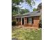 Traditional brick house with a dark front door and black shutters, set on a green lawn at 4712 Rockstile Way, Stone Mountain, GA 30083