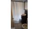 The bathroom has a pedestal sink, mosaic tile accent, and a shower with a classic white curtain at 4064 Sunset Sw Dr, Atlanta, GA 30331