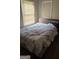 A bedroom with a plaid headboard bed and window for natural light is a serene retreat at 4064 Sunset Sw Dr, Atlanta, GA 30331