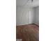 A cozy bedroom with hardwood floors and wood panel walls is ready for personalization and comfort at 4064 Sunset Sw Dr, Atlanta, GA 30331