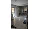 Bright and functional kitchen with tile flooring, a connecting porch, and ample cabinet space at 4064 Sunset Sw Dr, Atlanta, GA 30331