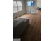 A bright living room featuring hardwood floors and a large window, creating a warm and inviting atmosphere at 4064 Sunset Sw Dr, Atlanta, GA 30331