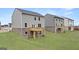 Exterior view of the home's backyard showing a brick foundation, wood deck, and green space at 588 Whitman Ln # 23, Stockbridge, GA 30281