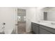 Bathroom featuring double sinks with marble countertops and gray cabinetry at 588 Whitman Ln # 23, Stockbridge, GA 30281