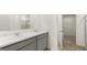 Bathroom featuring double sinks with marble countertops and view of the walk-in closet at 588 Whitman Ln # 23, Stockbridge, GA 30281