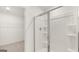 Modern bathroom featuring a glass-enclosed shower and a glimpse into the walk-in closet at 588 Whitman Ln # 23, Stockbridge, GA 30281