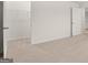 Bedroom featuring neutral carpet and open doorway to a walk-in closet at 588 Whitman Ln # 23, Stockbridge, GA 30281