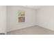A bedroom with neutral carpet and a window with blinds at 588 Whitman Ln # 23, Stockbridge, GA 30281