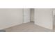 A bedroom with neutral carpet and a doorway to a closet at 588 Whitman Ln # 23, Stockbridge, GA 30281
