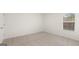 Bright bedroom featuring neutral carpet, white walls, and a window with blinds at 588 Whitman Ln # 23, Stockbridge, GA 30281