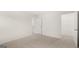 Spacious bedroom with neutral carpet and two open doorways at 588 Whitman Ln # 23, Stockbridge, GA 30281