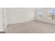 Expansive bedroom with neutral carpeting and two bright windows at 588 Whitman Ln # 23, Stockbridge, GA 30281