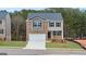 Two-story home with a brick and siding exterior and a two-car garage at 588 Whitman Ln # 23, Stockbridge, GA 30281