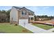 A charming two-story home with a brick and gray siding exterior, an attached garage, and a well-manicured lawn at 588 Whitman Ln # 23, Stockbridge, GA 30281
