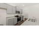 Kitchen with gray cabinets, granite countertops, stainless steel appliances, and walk-in pantry at 588 Whitman Ln # 23, Stockbridge, GA 30281