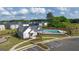 An aerial view of the community pool and clubhouse with parking and new homes in the background at 588 Whitman Ln # 23, Stockbridge, GA 30281