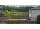 Backyard with a wooden fence, green lawn and landscaping that backs up to a pond at 883 Ironhorse Sw Ln, Mableton, GA 30126
