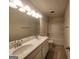 Bathroom features a dual sink vanity, a mirror, and a shower-tub combo at 883 Ironhorse Sw Ln, Mableton, GA 30126