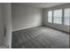 A spacious, carpeted bedroom features large windows and neutral walls at 883 Ironhorse Sw Ln, Mableton, GA 30126