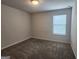 A carpeted bedroom features a window, neutral walls and trim at 883 Ironhorse Sw Ln, Mableton, GA 30126