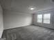 This spacious bedroom features carpet flooring and windows for natural light at 883 Ironhorse Sw Ln, Mableton, GA 30126