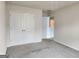 A carpeted bedroom features a double door closet and access to other rooms at 883 Ironhorse Sw Ln, Mableton, GA 30126