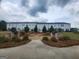 View of the rear of multiple homes with a nicely landscaped common area and walkway at 883 Ironhorse Sw Ln, Mableton, GA 30126