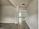 Bright hallway with wood-look flooring, leading to a sunlit room with large windows at 883 Ironhorse Sw Ln, Mableton, GA 30126