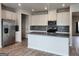 Modern kitchen featuring stainless steel appliances, gray countertops, and stylish backsplash at 883 Ironhorse Sw Ln, Mableton, GA 30126