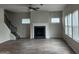 Cozy living room featuring a fireplace, natural light, and hardwood flooring at 883 Ironhorse Sw Ln, Mableton, GA 30126