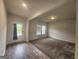 Spacious living room with plush carpeting, large windows, and a door to the exterior at 883 Ironhorse Sw Ln, Mableton, GA 30126