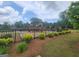 Neighborhood playground with a wooden structure, green grass, and an iron fence at 883 Ironhorse Sw Ln, Mableton, GA 30126