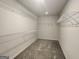 Spacious walk-in closet with multiple wire shelves and plush carpet flooring at 883 Ironhorse Sw Ln, Mableton, GA 30126