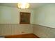 Bedroom featuring one window, striped lower walls, wood trim, and a ceiling light at 3296 Columbia Woods Dr, Decatur, GA 30032