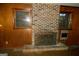 Cozy living room with a traditional brick fireplace and wood paneling at 3296 Columbia Woods Dr, Decatur, GA 30032