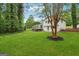Spacious backyard with lush green grass and a deck, perfect for outdoor entertaining and relaxation at 4327 Welligton Hill Ln, Snellville, GA 30039