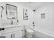 Bright bathroom featuring a modern vanity, toilet, and bathtub with herringbone tile surround at 4327 Welligton Hill Ln, Snellville, GA 30039