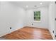 An empty bedroom features hardwood floors, recessed lighting, and a window at 4327 Welligton Hill Ln, Snellville, GA 30039