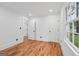 Bedroom showcasing hardwood floors, a large window, and white trim at 4327 Welligton Hill Ln, Snellville, GA 30039