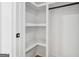 Bright white walk-in closet with adjustable shelving and a hanging rod for optimal organization at 4327 Welligton Hill Ln, Snellville, GA 30039