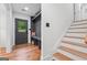 Bright foyer with a convenient bench, coat hooks, and stylish staircase at 4327 Welligton Hill Ln, Snellville, GA 30039