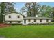 Charming, renovated home features white brick and siding, a bright blue door, and well-manicured landscaping at 4327 Welligton Hill Ln, Snellville, GA 30039