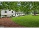 Classic home with light exterior, manicured lawn, pretty landscaping and a long driveway with detached garage at 4327 Welligton Hill Ln, Snellville, GA 30039