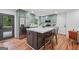 A contemporary kitchen featuring an island with a marble countertop, stainless steel appliances and wood flooring at 4327 Welligton Hill Ln, Snellville, GA 30039